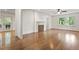 Sun-filled living room featuring hardwood floors, a fireplace, and access to the porch at 124 Lord Ashley Rd, Raleigh, NC 27610