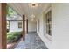 A welcoming covered porch with stone floors and a beadboard ceiling at 124 Lord Ashley Rd, Raleigh, NC 27610