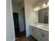 Well-lit bathroom featuring double sinks, modern lighting, and a walk-in shower at 125 Fraiser Fir Way, Lillington, NC 27546