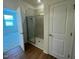 Modern bathroom with glass shower, light tile, and wood flooring at 125 Fraiser Fir Way, Lillington, NC 27546