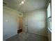 A carpeted bedroom featuring a window and a door at 125 Fraiser Fir Way, Lillington, NC 27546