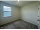 Bright bedroom features gray carpet, a window with blinds, and neutral walls at 125 Fraiser Fir Way, Lillington, NC 27546