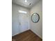 A bright entryway features a round mirror and a white door leading to other parts of the home at 125 Fraiser Fir Way, Lillington, NC 27546