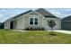 Inviting one-story home featuring a well-maintained lawn and garden beds, complemented by a two-car garage at 125 Fraiser Fir Way, Lillington, NC 27546