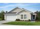 Charming single-story home features a two-car garage, neutral siding, and a well-manicured front yard at 125 Fraiser Fir Way, Lillington, NC 27546