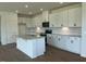 Modern kitchen featuring white cabinets, stainless steel appliances, gray countertops, and a center island at 125 Fraiser Fir Way, Lillington, NC 27546