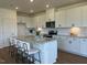 Bright kitchen featuring a large island, granite countertops and modern white cabinets at 125 Fraiser Fir Way, Lillington, NC 27546