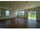 Open-concept living area with wood floors and a large sliding glass door to the outside at 125 Fraiser Fir Way, Lillington, NC 27546