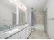 Large bathroom featuring double sink vanity with granite countertop and tiled shower at 1300 St Marys St # 408, Raleigh, NC 27605