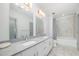 Bathroom featuring double vanity with granite countertop and tiled shower at 1300 St Marys St # 408, Raleigh, NC 27605