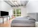 Bedroom featuring a large window, ceiling fan, and hardwood floors at 1300 St Marys St # 408, Raleigh, NC 27605