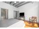 Bedroom with an industrial ceiling and a view to the en-suite bathroom and closet at 1300 St Marys St # 408, Raleigh, NC 27605