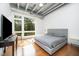 Bright bedroom with hardwood floors, ceiling fan, and large window with a view at 1300 St Marys St # 408, Raleigh, NC 27605