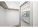 Spacious walk-in closet leading into bathroom featuring a double vanity and granite countertops at 1300 St Marys St # 408, Raleigh, NC 27605
