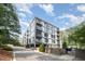 Modern condo building featuring sleek architecture, multiple balconies, and lush landscaping creating inviting curb appeal at 1300 St Marys St # 408, Raleigh, NC 27605