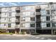Modern condo building with multiple balconies, large windows, well-maintained landscaping, and convenient covered parking at 1300 St Marys St # 408, Raleigh, NC 27605