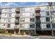 Modern condo building with multiple balconies, large windows, well-maintained landscaping, and convenient covered parking at 1300 St Marys St # 408, Raleigh, NC 27605