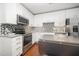 Modern kitchen featuring white cabinets, stainless steel appliances, and a stylish backsplash at 1300 St Marys St # 408, Raleigh, NC 27605