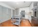 Bright kitchen featuring an island with seating, stainless appliances, and gray cabinets at 1300 St Marys St # 408, Raleigh, NC 27605