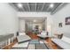 Open floor plan with hardwood floors, modern furniture, and an adjacent kitchen area at 1300 St Marys St # 408, Raleigh, NC 27605