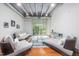 Bright living room with hardwood floors, modern furniture, and a sliding glass door to a balcony at 1300 St Marys St # 408, Raleigh, NC 27605