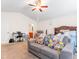 Cozy bedroom featuring a comfortable sitting area, ceiling fan, and a functional desk space at 131 Botanical Ct, Bunnlevel, NC 28323
