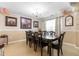 Dining room with large table, chairs, and bright lighting from a chandelier at 131 Botanical Ct, Bunnlevel, NC 28323