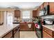 Functional kitchen featuring wood cabinets, modern appliances, and ample counter space at 131 Botanical Ct, Bunnlevel, NC 28323