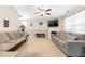 Comfortable living room with a fireplace, ceiling fan, and lots of seating at 131 Botanical Ct, Bunnlevel, NC 28323