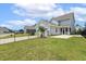 View of the backyard with green grass and a black fence, offering a private outdoor space at 141 Beldenshire Way, Holly Springs, NC 27540