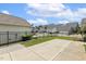 Concrete patio with black fencing, offering an outdoor space for relaxation and entertainment at 141 Beldenshire Way, Holly Springs, NC 27540