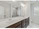 Modern bathroom featuring double sinks, tile flooring, and a large mirror at 141 Beldenshire Way, Holly Springs, NC 27540
