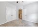 Bright bedroom with carpet, white walls, and an open doorway to a connecting room at 141 Beldenshire Way, Holly Springs, NC 27540