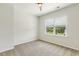 Inviting bedroom with plush carpet, a ceiling fan, and a window with natural light at 141 Beldenshire Way, Holly Springs, NC 27540