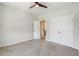 Bright bedroom with plush carpet, a ceiling fan, closet, and ensuite bathroom at 141 Beldenshire Way, Holly Springs, NC 27540