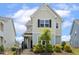 Charming two-story home with a landscaped front yard and inviting entrance at 141 Beldenshire Way, Holly Springs, NC 27540