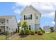 Charming two-story home with a landscaped front yard and inviting entrance at 141 Beldenshire Way, Holly Springs, NC 27540