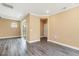 Living room with hardwood floors, recessed lighting, a balcony, and a door to the bedroom at 141 Beldenshire Way, Holly Springs, NC 27540
