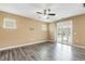 This is a living room with wood floors, recessed lighting, and sliding glass doors to the porch at 141 Beldenshire Way, Holly Springs, NC 27540