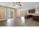 Open-concept living room features sliding glass doors and modern kitchen nearby at 141 Beldenshire Way, Holly Springs, NC 27540