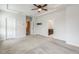 This is a carpeted main bedroom with a ceiling fan and doorways to a closet and bathroom at 141 Beldenshire Way, Holly Springs, NC 27540