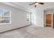 Spacious main bedroom with a ceiling fan, ensuite and large windows for plenty of natural light at 141 Beldenshire Way, Holly Springs, NC 27540