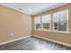 Room with hardwood floors, base trim, and three windows with blinds at 141 Beldenshire Way, Holly Springs, NC 27540