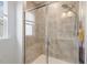 Glass enclosed shower with tile surround, built-in bench and showerhead at 141 Beldenshire Way, Holly Springs, NC 27540