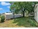 Beautiful backyard featuring a lush lawn, mature trees, and a privacy fence at 141 S Broad E St, Angier, NC 27501