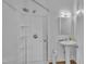 Modern bathroom featuring a sleek glass-enclosed shower and pedestal sink at 141 S Broad E St, Angier, NC 27501