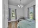 Sunlit bedroom showcasing wood floors and natural light from two well-placed windows at 141 S Broad E St, Angier, NC 27501