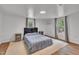 Cozy bedroom featuring hardwood floors, neutral decor, and plenty of natural light at 141 S Broad E St, Angier, NC 27501