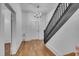 Bright entryway featuring hardwood floors, a decorative chandelier, and a wooden staircase at 141 S Broad E St, Angier, NC 27501