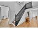Entryway with a wooden staircase, warm hardwood floors, and neutral décor at 141 S Broad E St, Angier, NC 27501